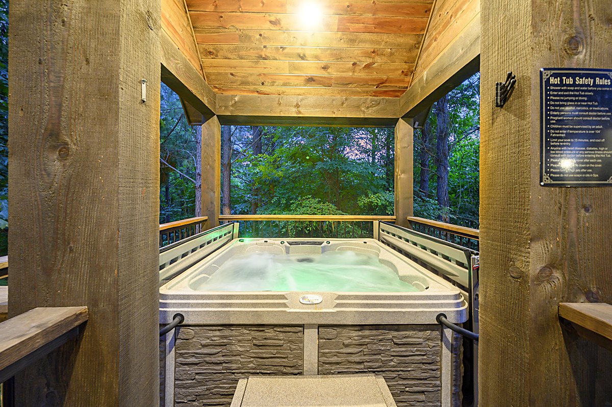 Hot tub glowing at dusk on its covered deck