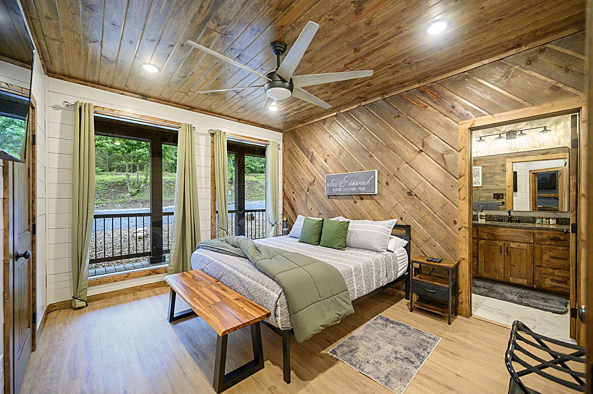 King suite with pine walls and forest views